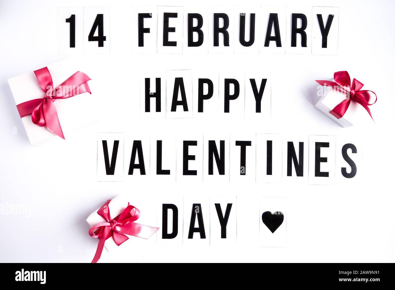 14 february, Happy valentines day text on white table background, with gift boxes Stock Photo