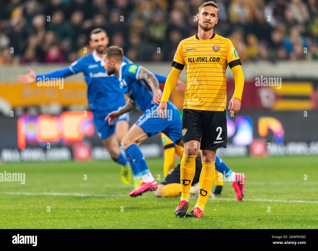 07 February 2020, Saxony, Dresden: Football: 2nd Bundesliga, SG Dynamo Dresden - SV Darmstadt 98, 21st matchday, at the Rudolf Harbig Stadium. Dynamos Linus Wahlqvist reacts disappointed while Darmstadt's Tobias Kempe (M) turns off to cheers after his goal for 1:2. Photo: Robert Michael/dpa-Zentralbild/dpa - IMPORTANT NOTE: In accordance with the regulations of the DFL Deutsche Fußball Liga and the DFB Deutscher Fußball-Bund, it is prohibited to exploit or have exploited in the stadium and/or from the game taken photographs in the form of sequence images and/or video-like photo series. Stock Photo