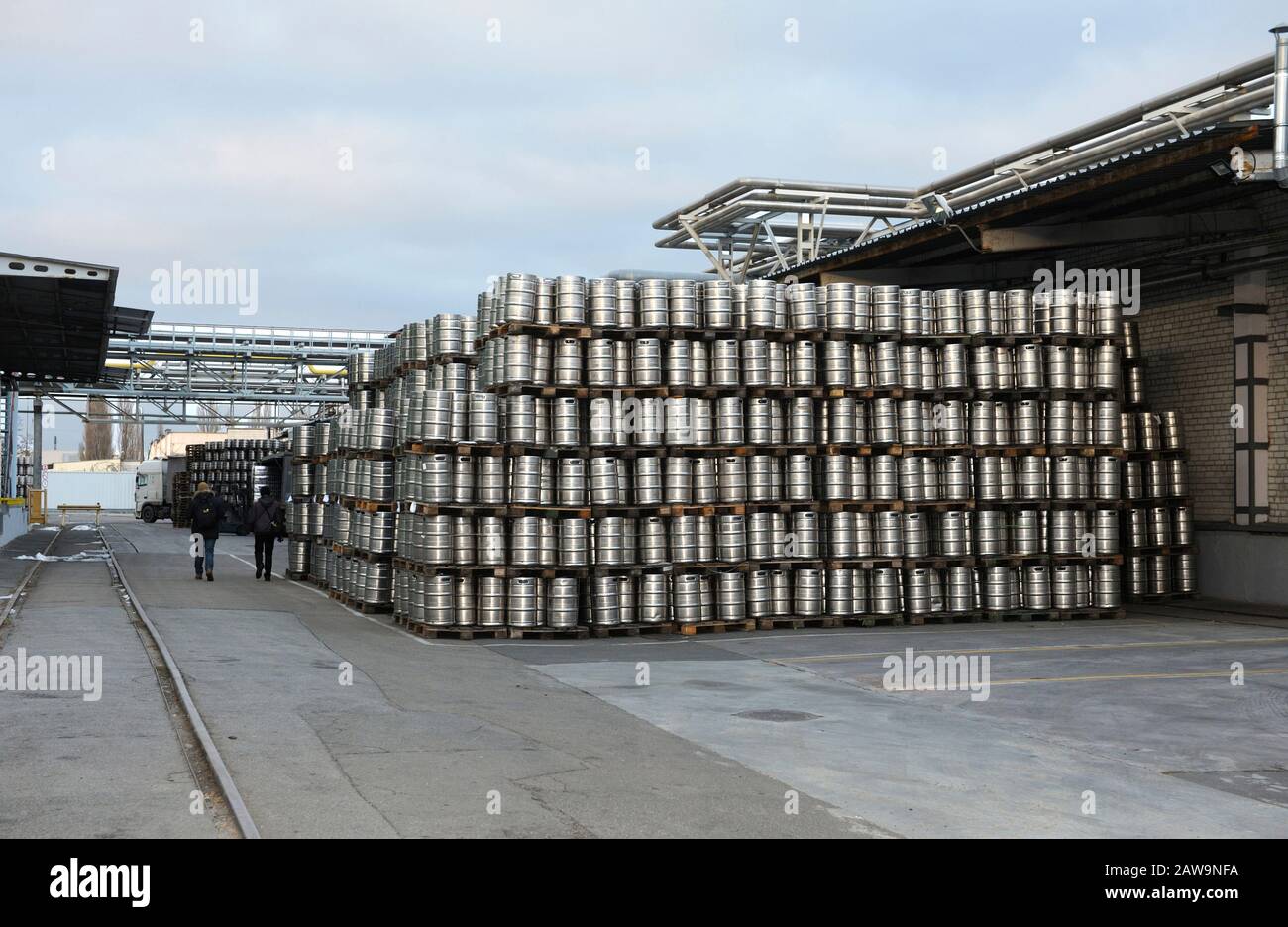 metal barrels stacked in a warehouse Stock Photo Alamy