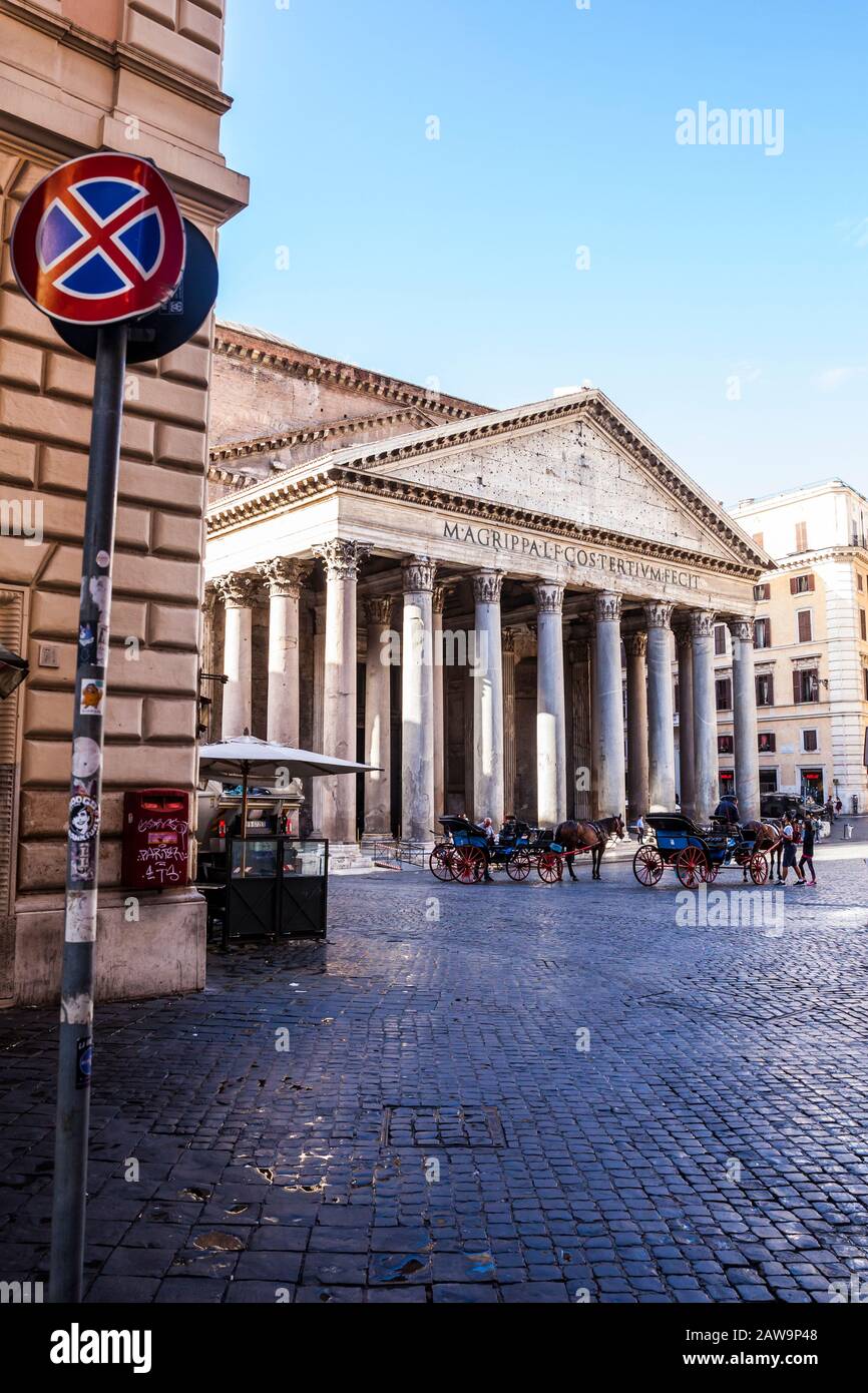 Tourists and guides in front of the Patheon in central Rome, Italy. The Pantheon is a former Roman temple and now a church completed in 126 AD Stock Photo