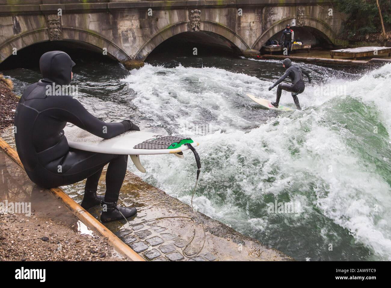 Surfer surfing an artificial wave in Munich city center, Germany Stock Photo