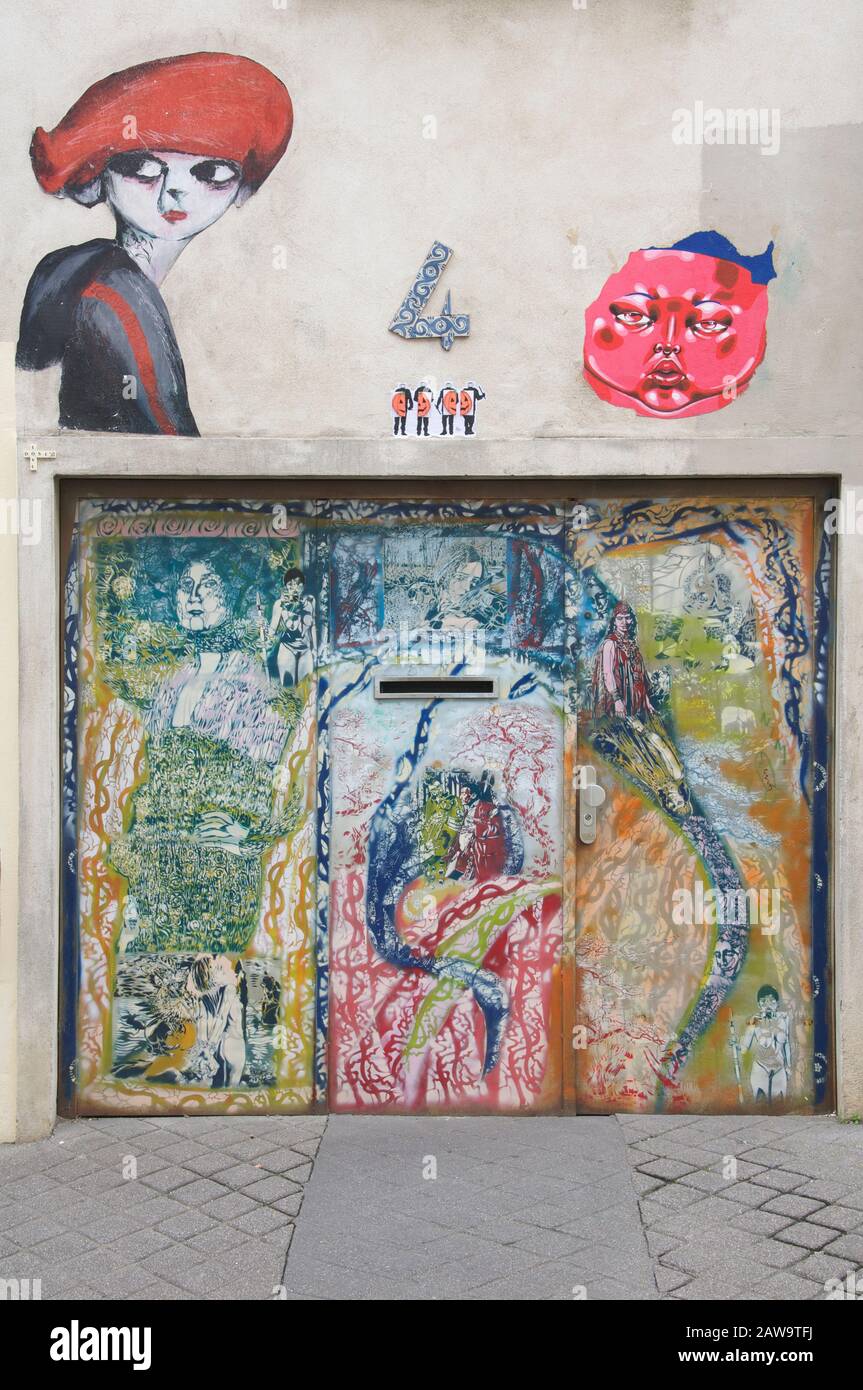Street art spray painted on a doorway with stencils, by graffiti artist Pierre Benoît Dumont AKA Artiste Ouvrier. La Butte aux Cailles, Paris, France. Stock Photo
