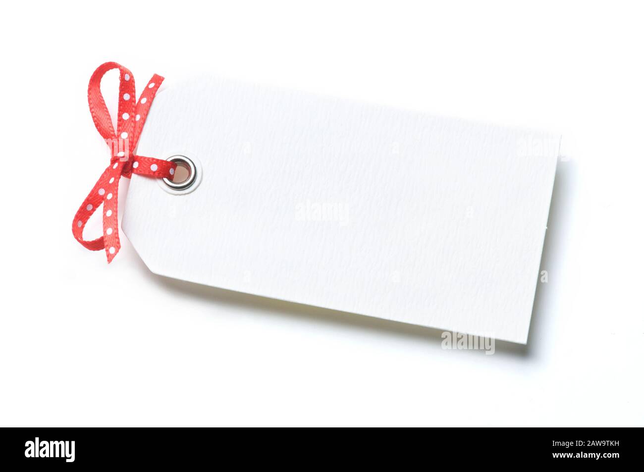 Blank white gift tag with red bow casting a shadow on white background