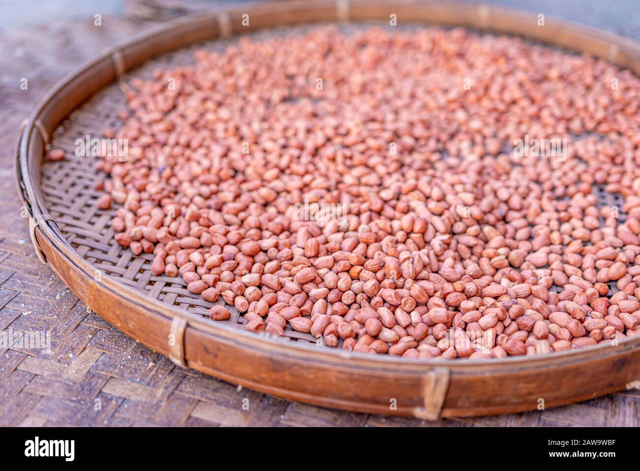 Shelled peanuts in a threshing basket, local market Stock Photo