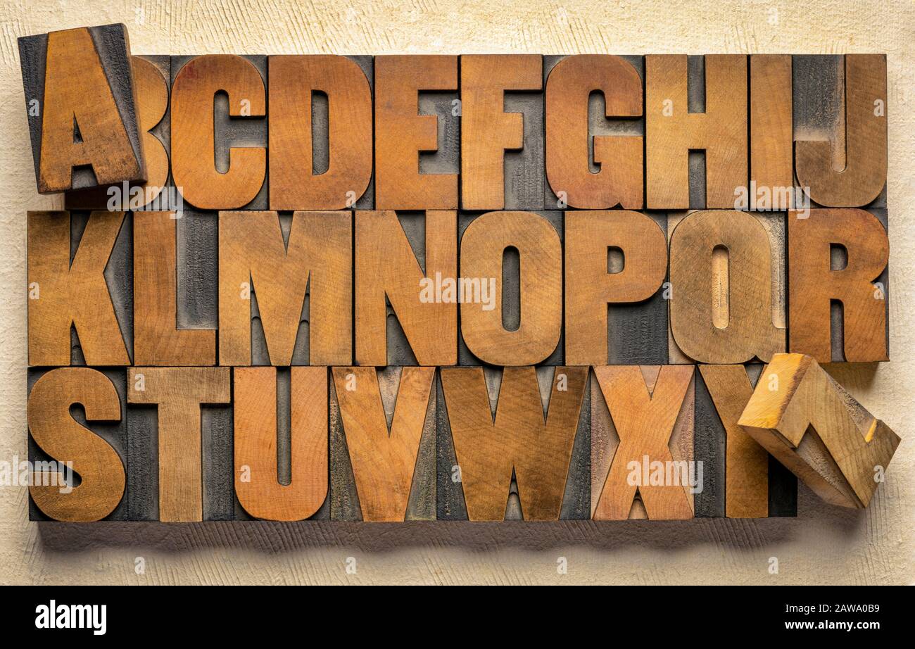 alphabet in vintage letterpress wood type printing blocks against handmade  bark paper Stock Photo - Alamy