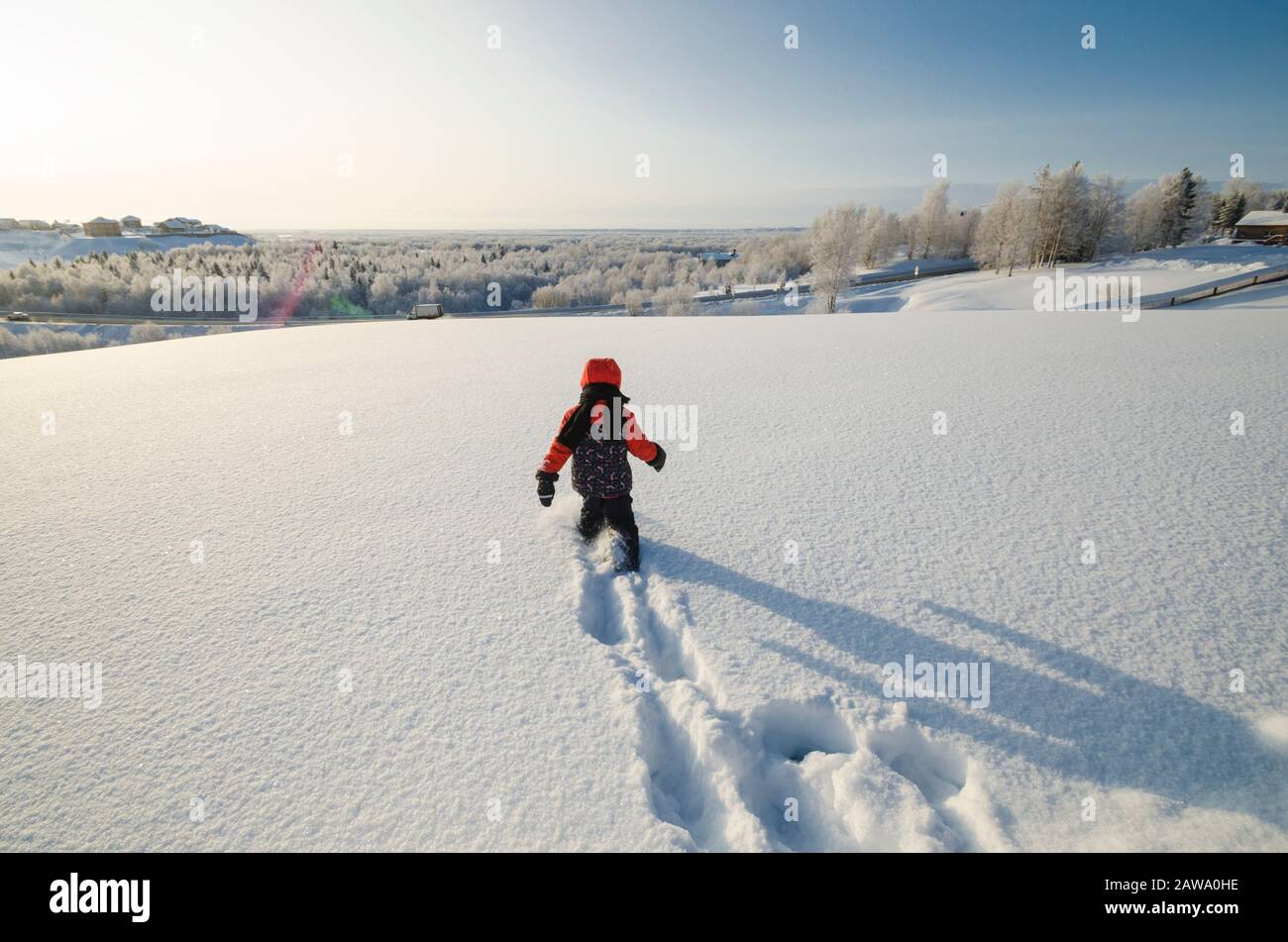 January 2020 - Malye Korely. The kid makes his way through the snowdrifts. Russia, Arkhangelsk region Stock Photo