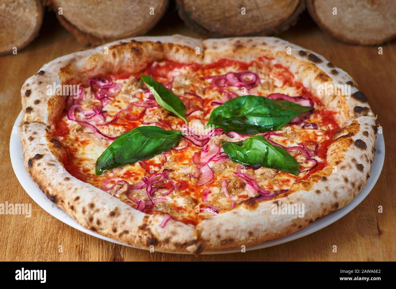 Italian Pizza With Tuna And Red Onion On A Wooden Board In A Rustic Kitchen Or Pizzeria On An Old Wooden Table Stock Photo Alamy