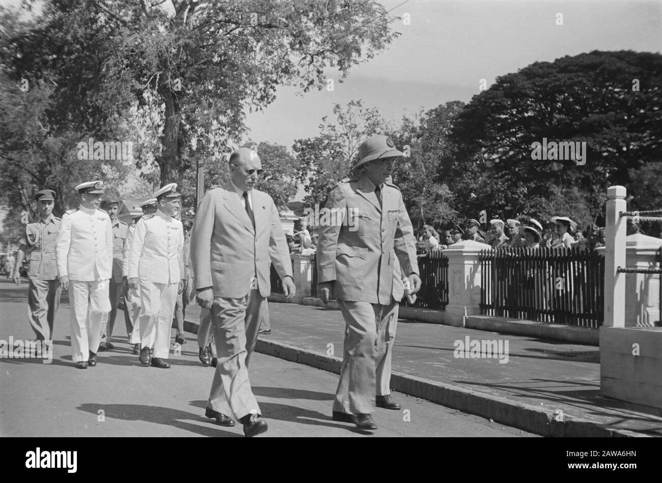 Parade t.g.v. birthday of Princess Juliana  Lieutenant Governor General Van Mook (pith helmet). Beside him Commissioner General Schermerhorn. the result including Vice Admiral Pinke Date: April 30, 1947 Location: Batavia, Indonesia, Jakarta, Dutch East Indies Stock Photo