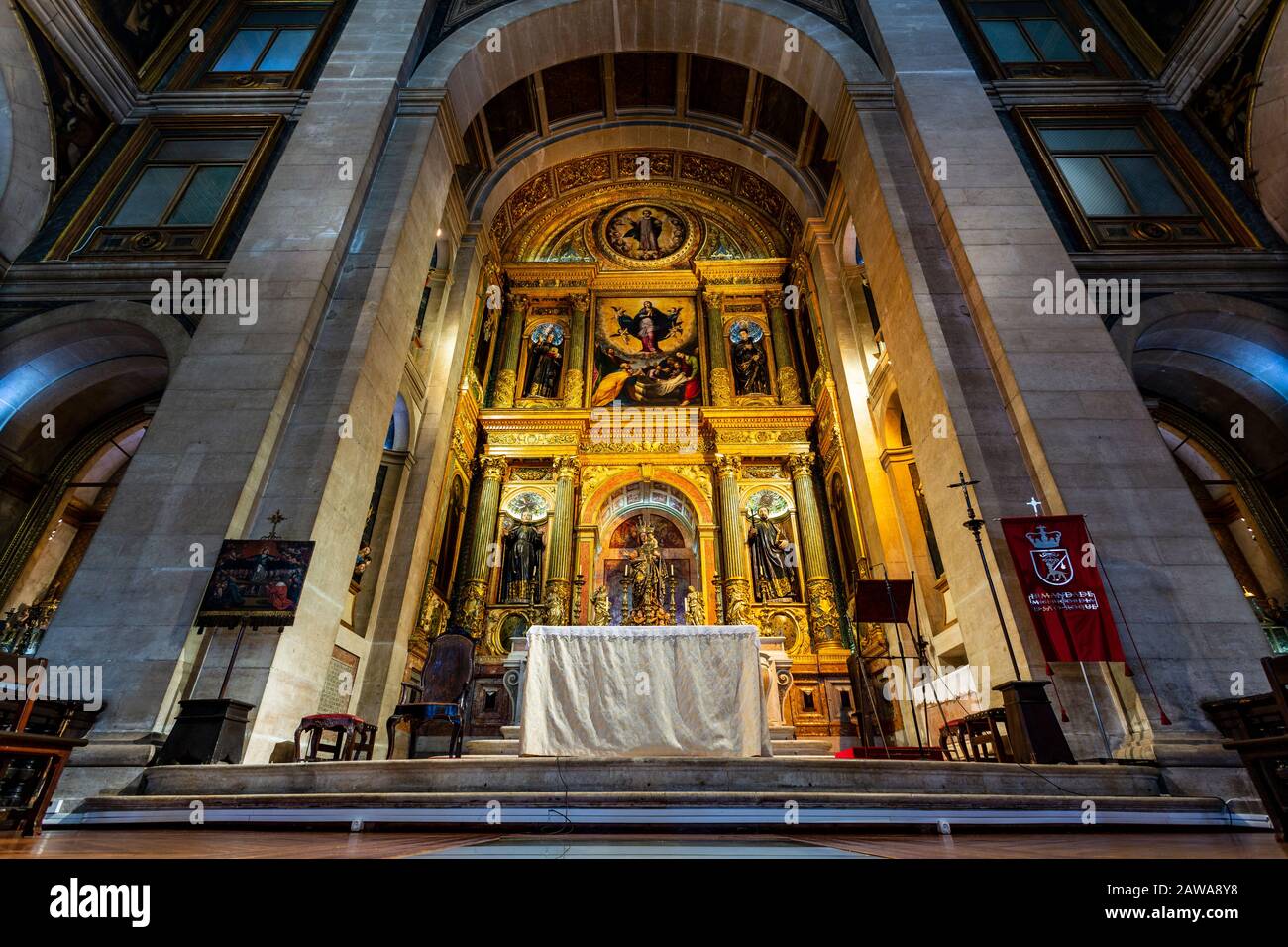 View of the chancel with a gilded altar piece and representation of the Jesuits greatest saints, in Bairro Alto, Lisbon, Portugal Stock Photo