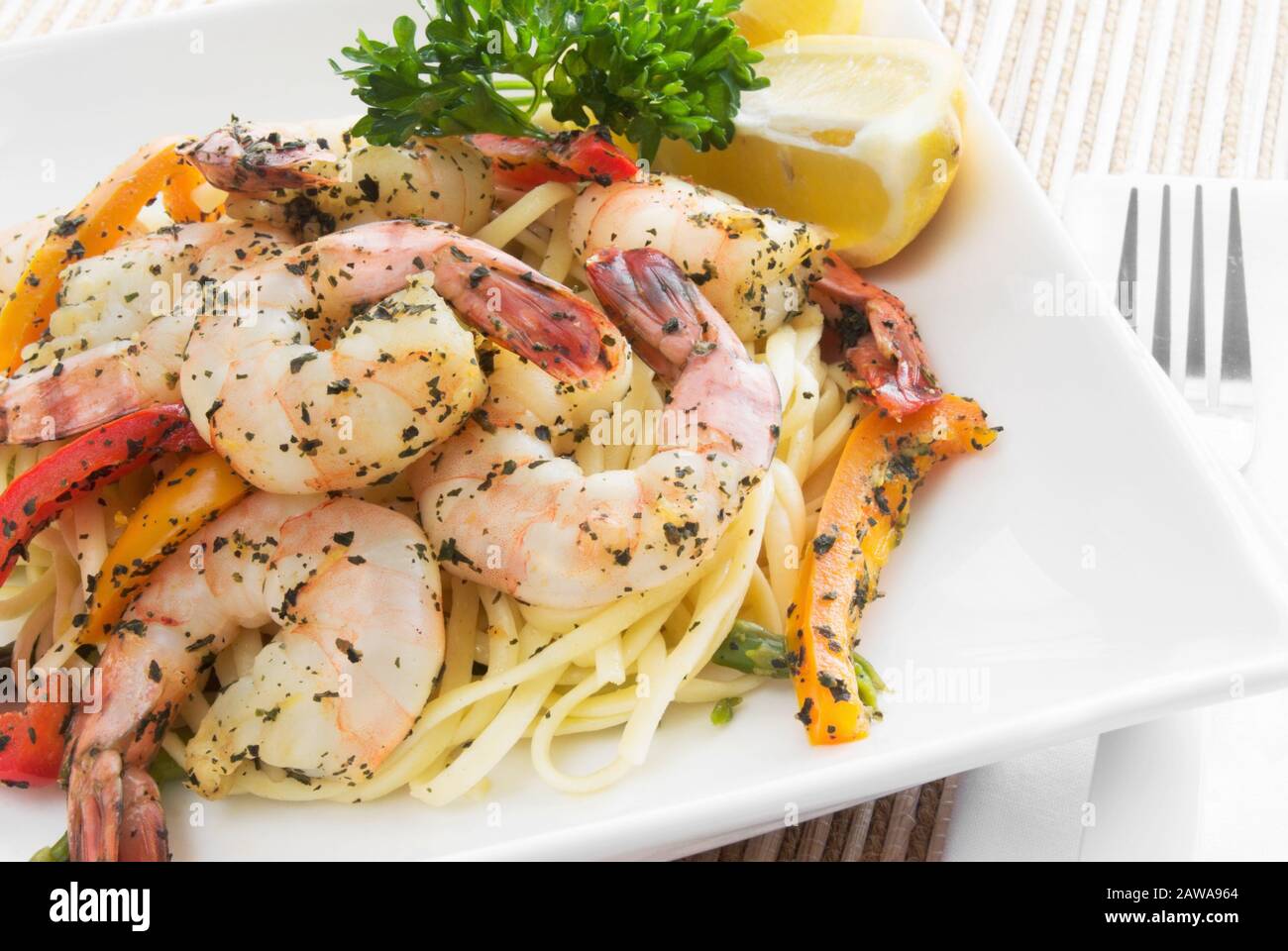 Homemade cooked shrimp and linguini pasta made with basil, lemon