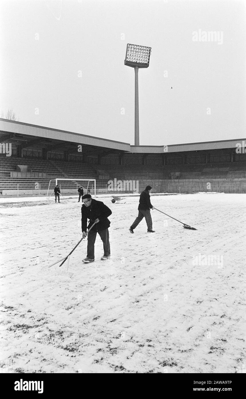 PSV stadium is snow cleared for football match against description: Men with snow blades Date: March 8, 1971 Location: Eindhoven, Noord-Brabant Keywords: snow, sports stadiums, football Institution Name: Vorwarts Berlin Stock Photo
