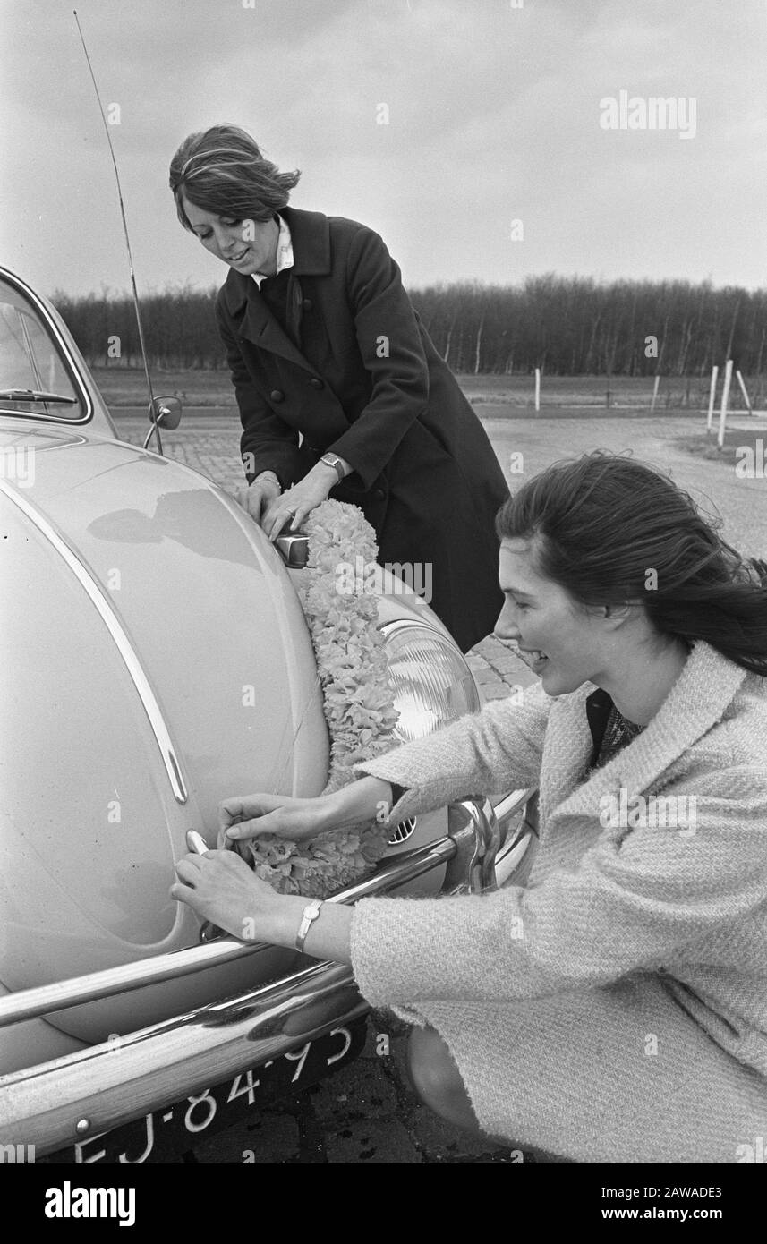Girl with bulbs garland flower garland confirm car Date March 27, 1966