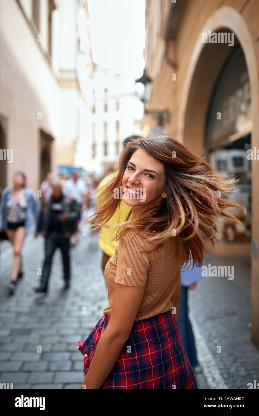 Smiling girl tourist walking in city streets on vacation tourism. Stock Photo
