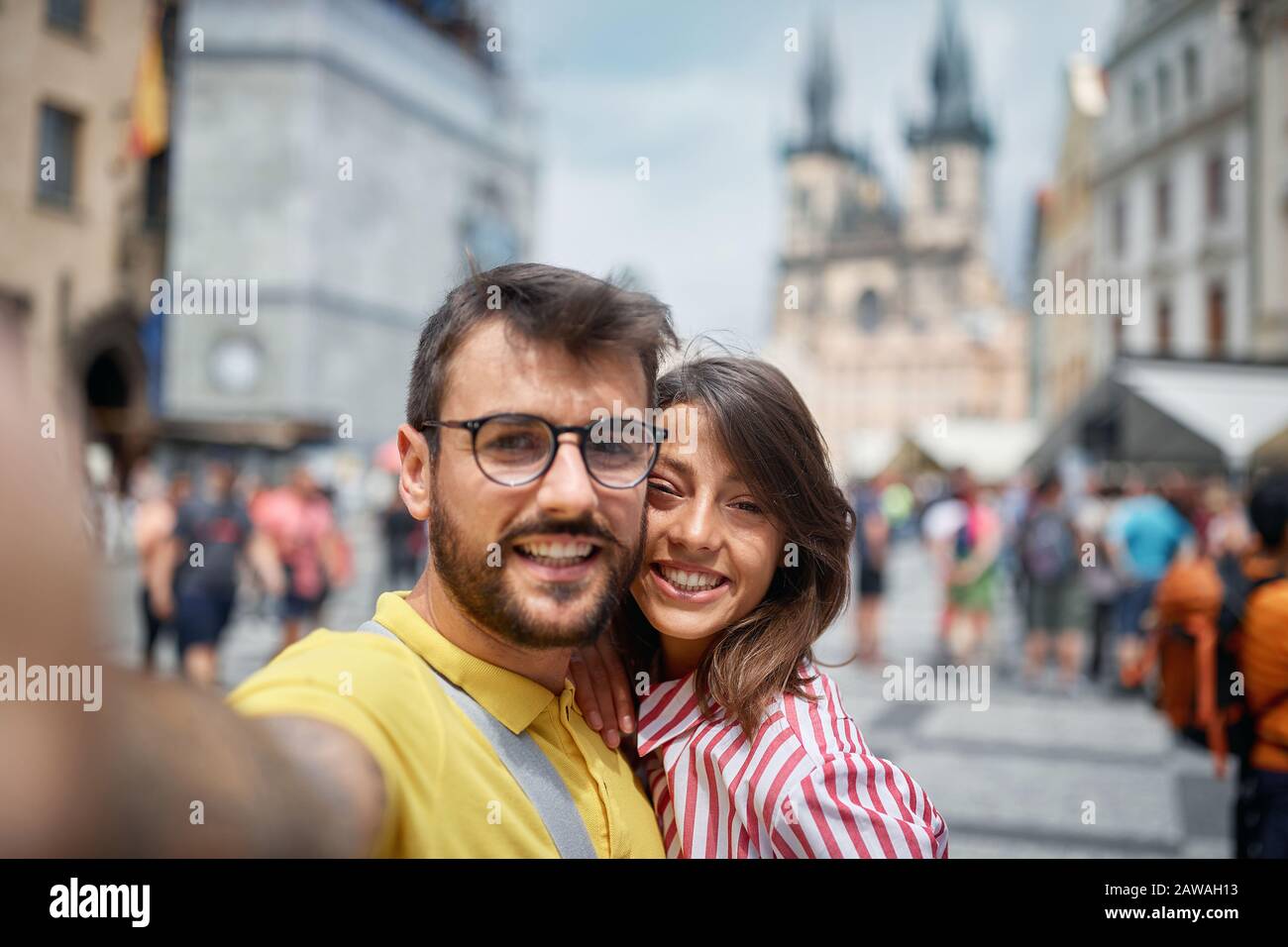 Smiling couple in a vacation trip in city streets at Prague  on vacation making selfie. Stock Photo