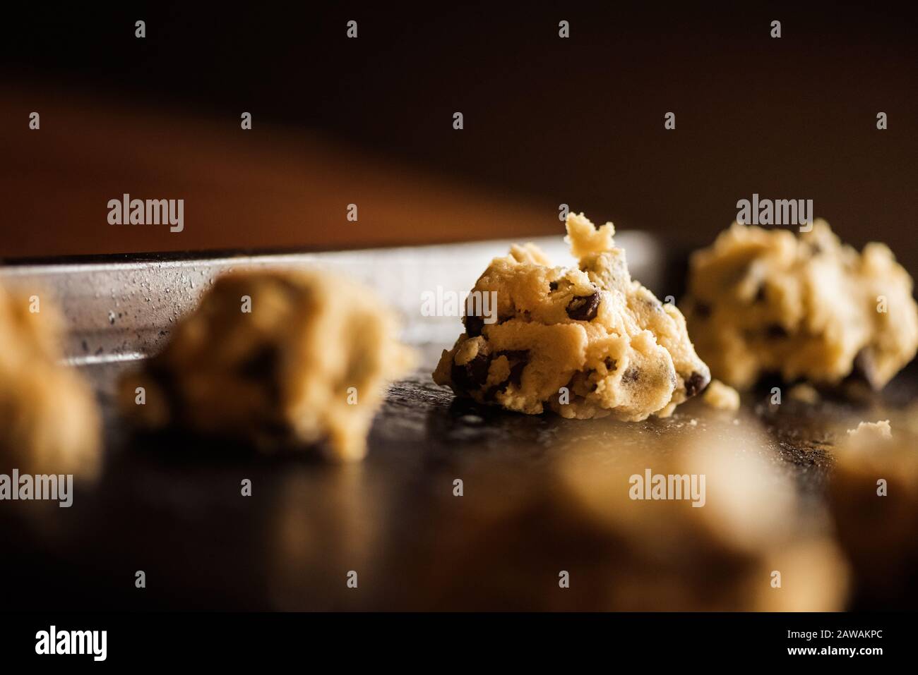 chocolate chip cookie dough on a stainless steal cookie sheet Stock Photo