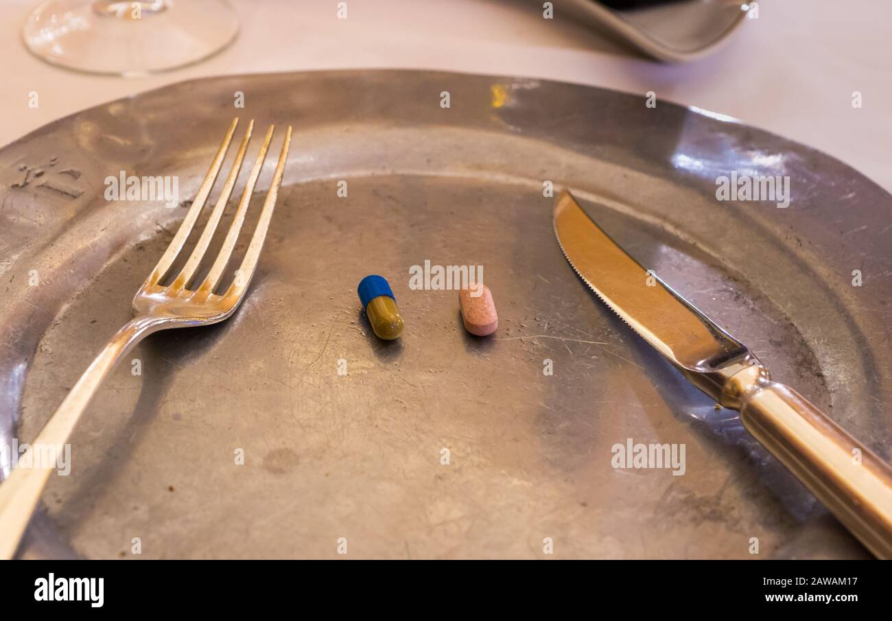 Two pills on a dinner plate Stock Photo