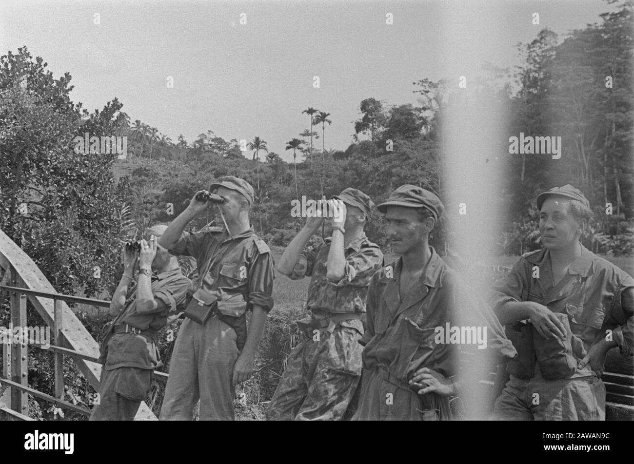 Photoreportage near Buitenzorg  Soldiers on a Bailey bridge. Two officers watching with binoculars Date: January 1947 Location: Bogor, Indonesia, Java, Dutch East Indies Stock Photo