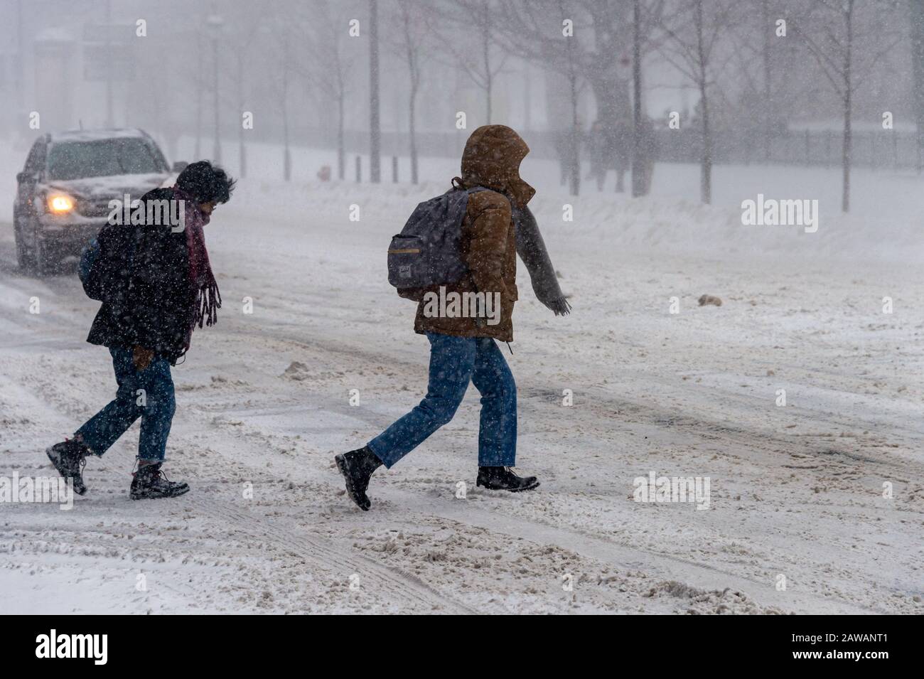 Montreal, CA - 7 February 2020: Pedestrians walking in Downtown Montreal during snow storm. Stock Photo