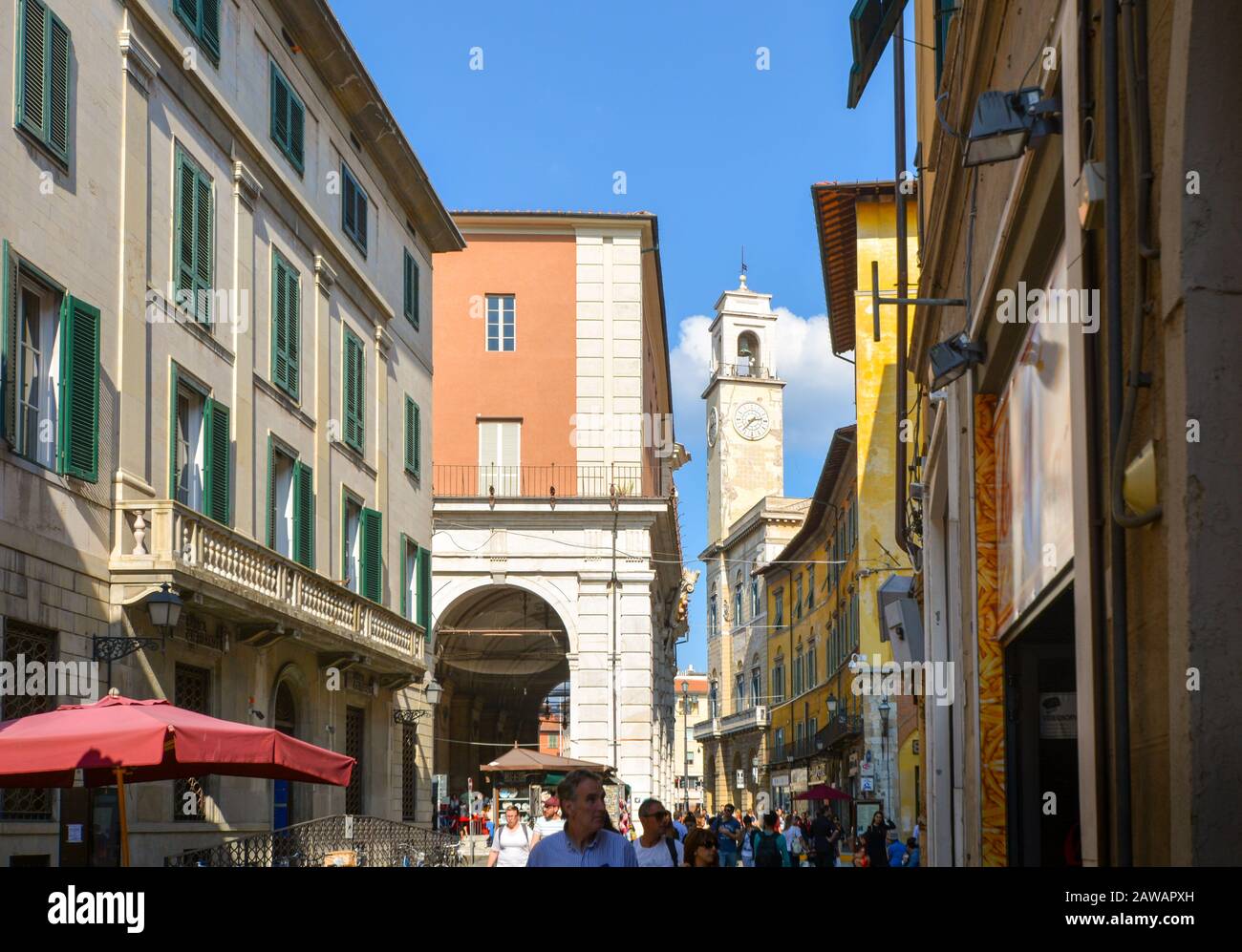 One Of The Many Church Bell Towers Above The Centro Storico Old Town Of Pisa Italy As Tourists Shop Under The Covered Porticos In Tuscany Stock Photo Alamy