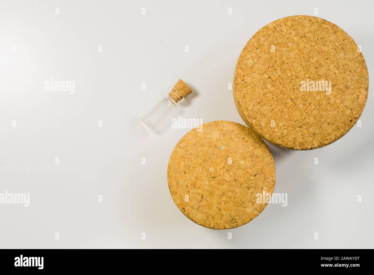 Empty little bottle with cork stopper isolated on white. glass vessel