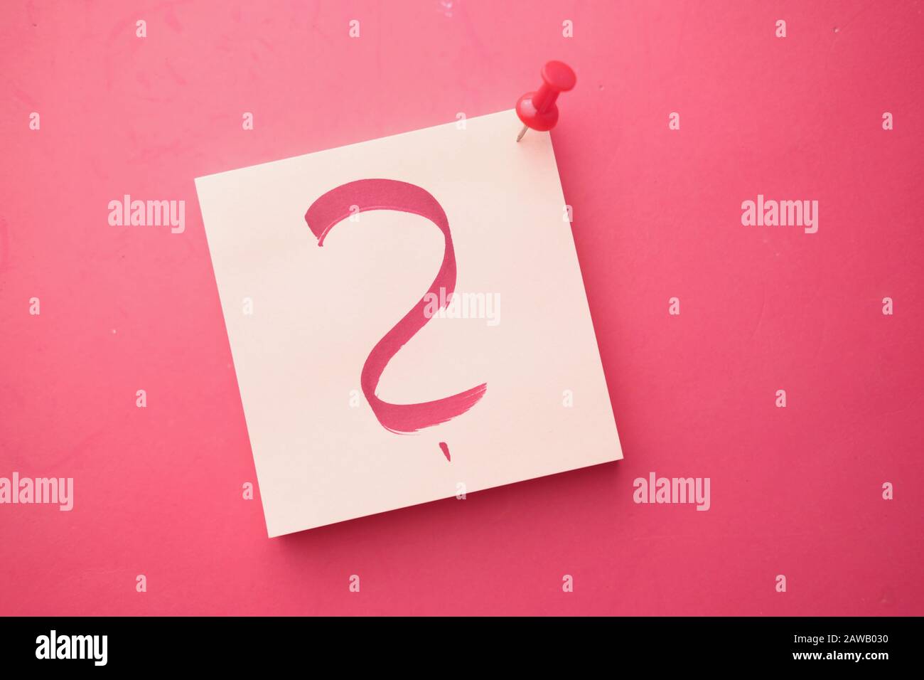 question mark on notepad on red background, top view  Stock Photo