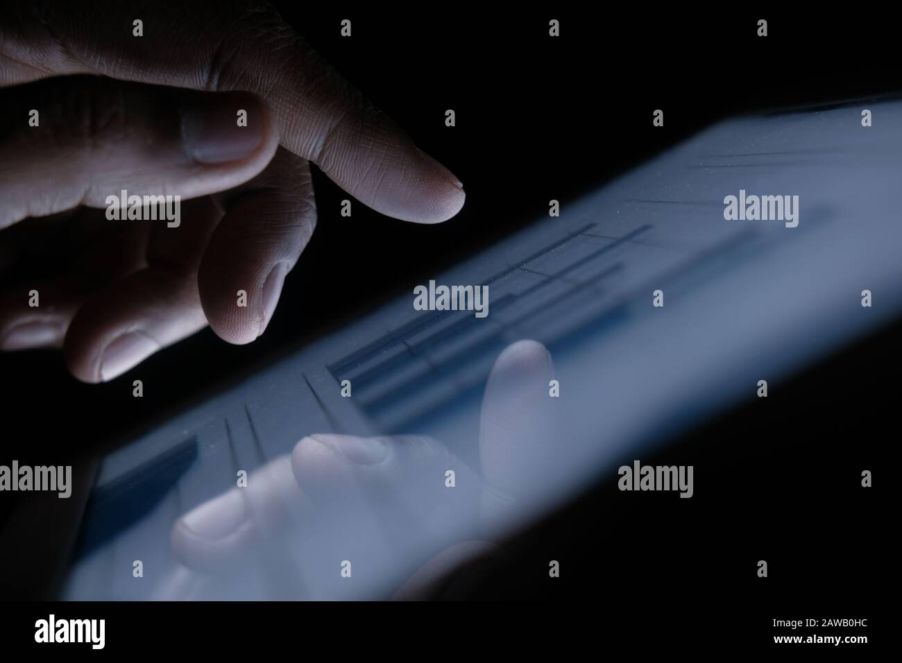 Man hand analyzing chart on digital table at night, close up Stock Photo