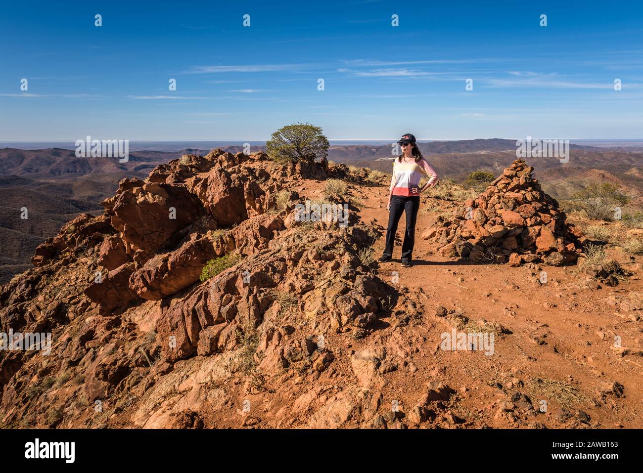 Eco-tourist stands atop Sillers Lookout on an Arkaroola ridgetop trek in the northern Flinders Ranges in South Australia. Stock Photo