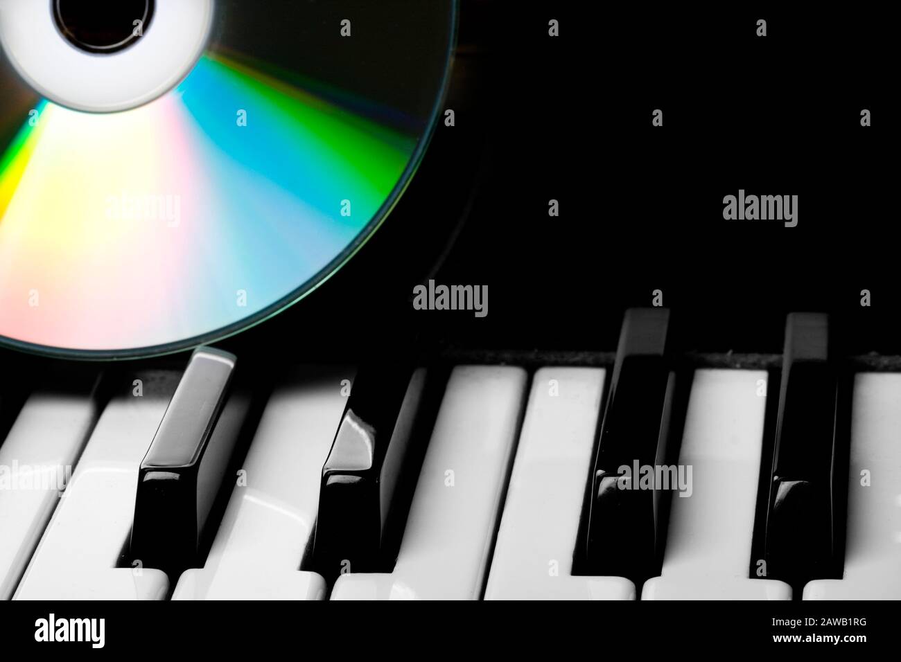 Image of the cd-drive, lying on the piano keys Stock Photo