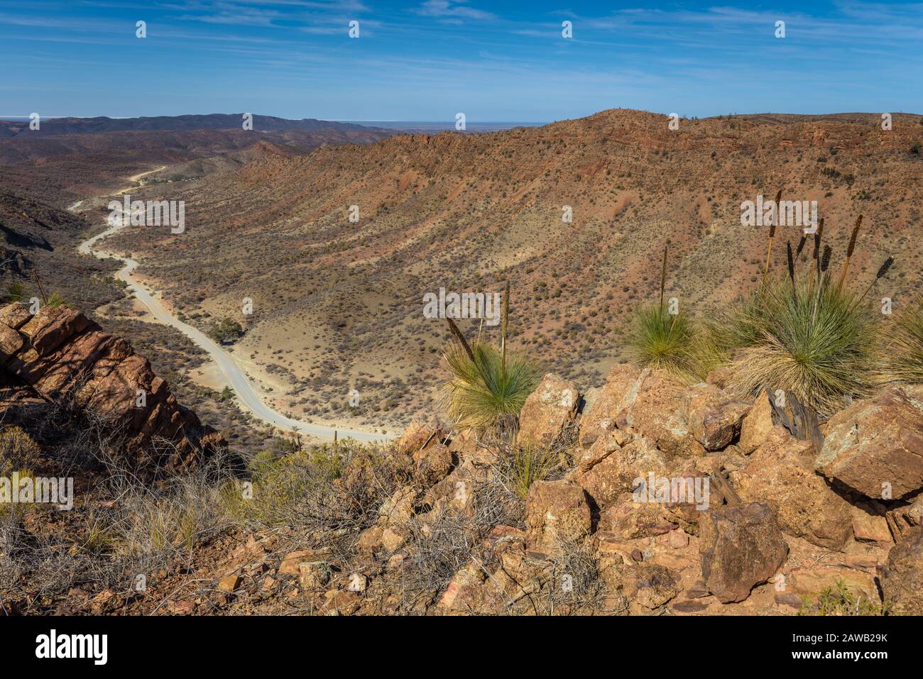 Ridge-top scenic view along the Gammon Range with the snaking dirt road winding its way through the valley into Arkaroola, South Australia. Stock Photo