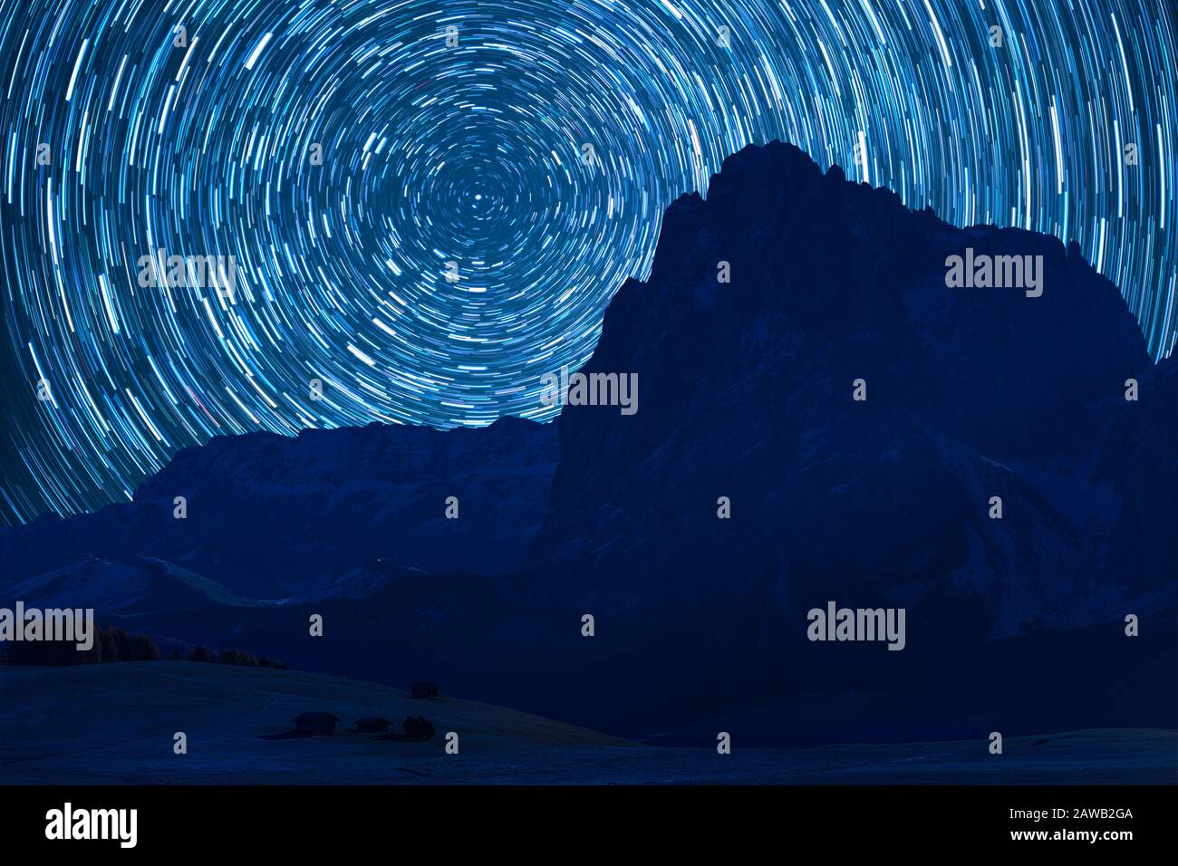 Night landscape with majestic mountains and stars in sky, long exposure. Space and Polar star over peaks. Mountaineering and climb background Stock Photo