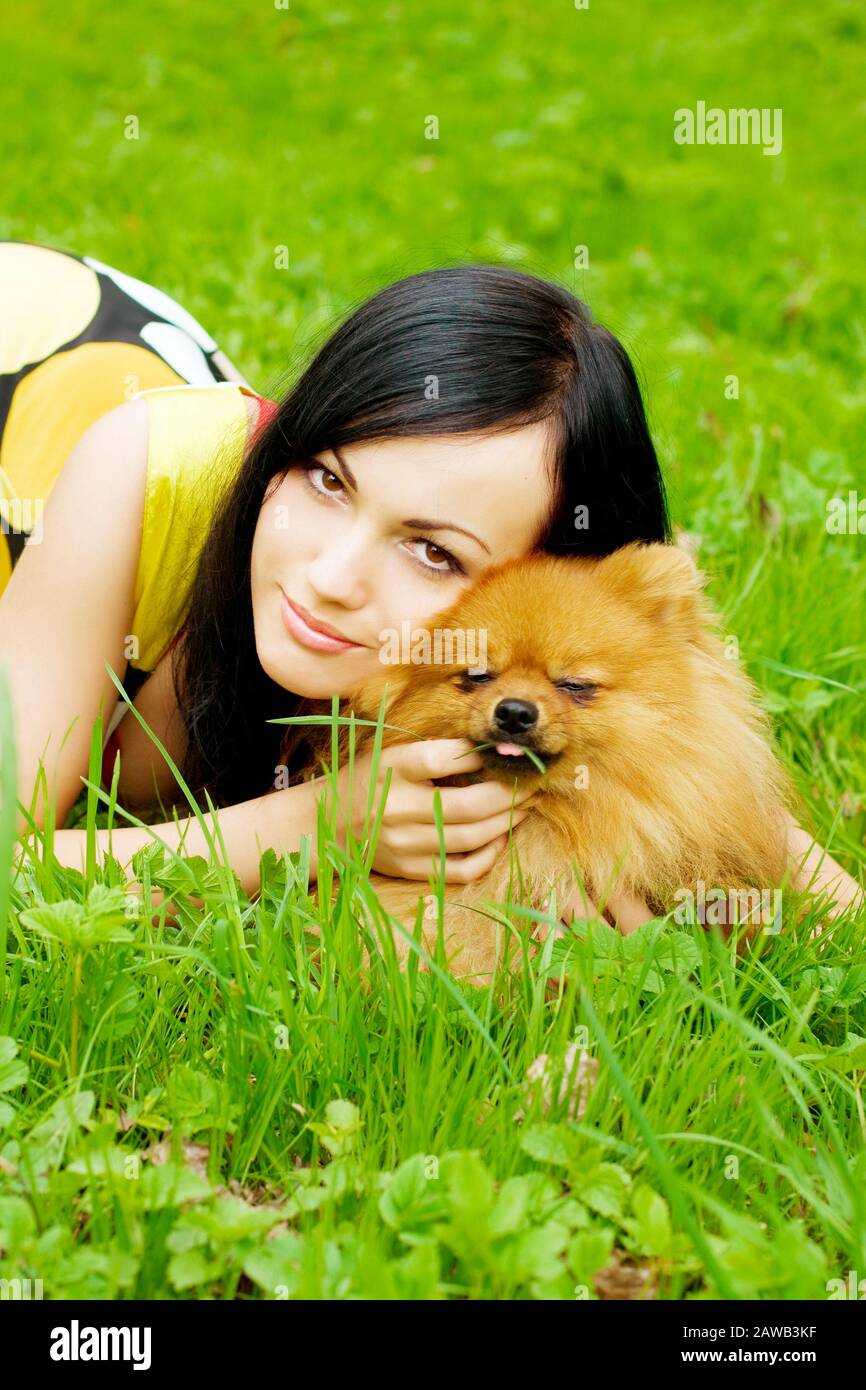 The image of a girl playing with a small dog in the park Stock Photo ...