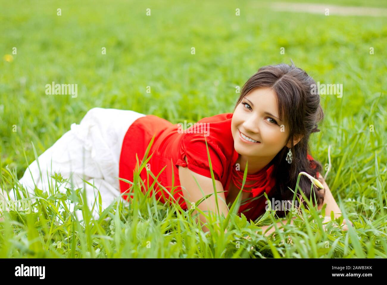 Picture of beautiful girl lying on the grass in the park Stock Photo ...
