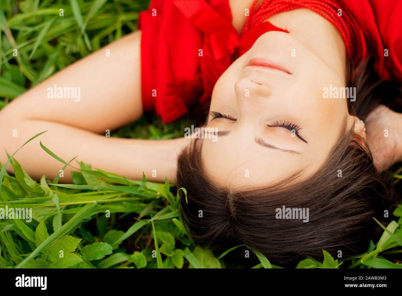 Picture of beautiful girl lying on the grass in the park Stock Photo ...