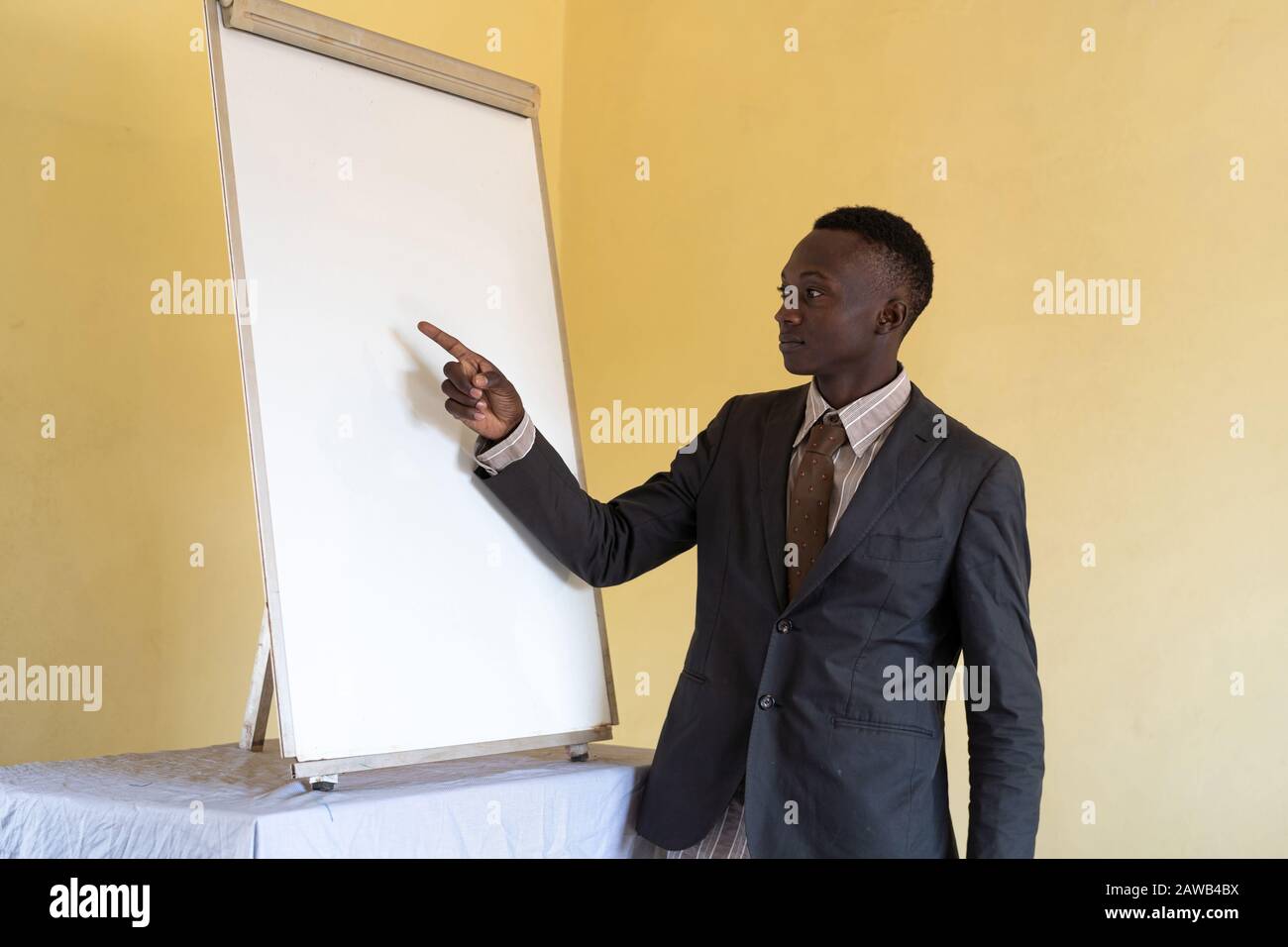 African ethnicity brave person brainstorming worker feeling confident in front of whiteboard Stock Photo