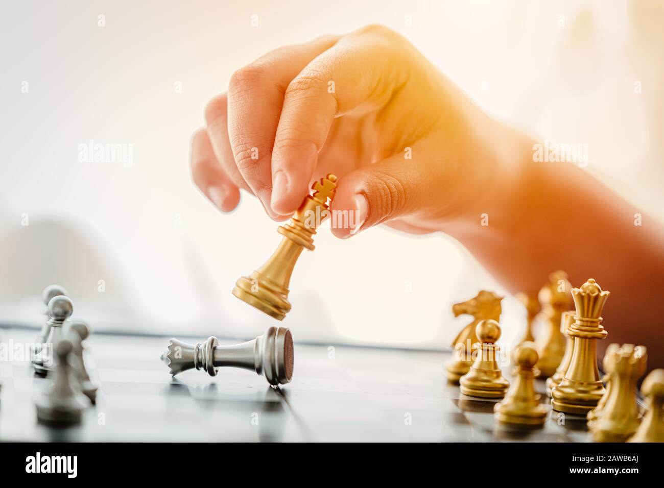 People hand playing Chess board game checkmate winner in business concept. Stock Photo