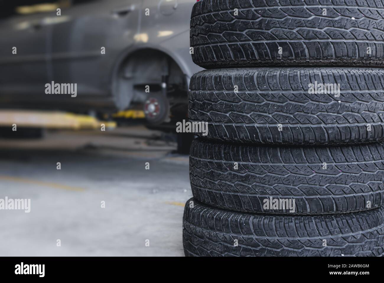 Car tire replace in garage, old tyre wheel service for background. Stock Photo