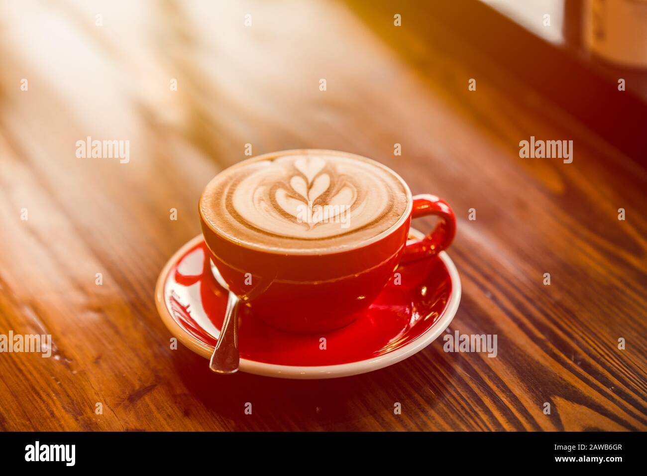 Latte art hot coffee on wooden table in the morning day Stock Photo