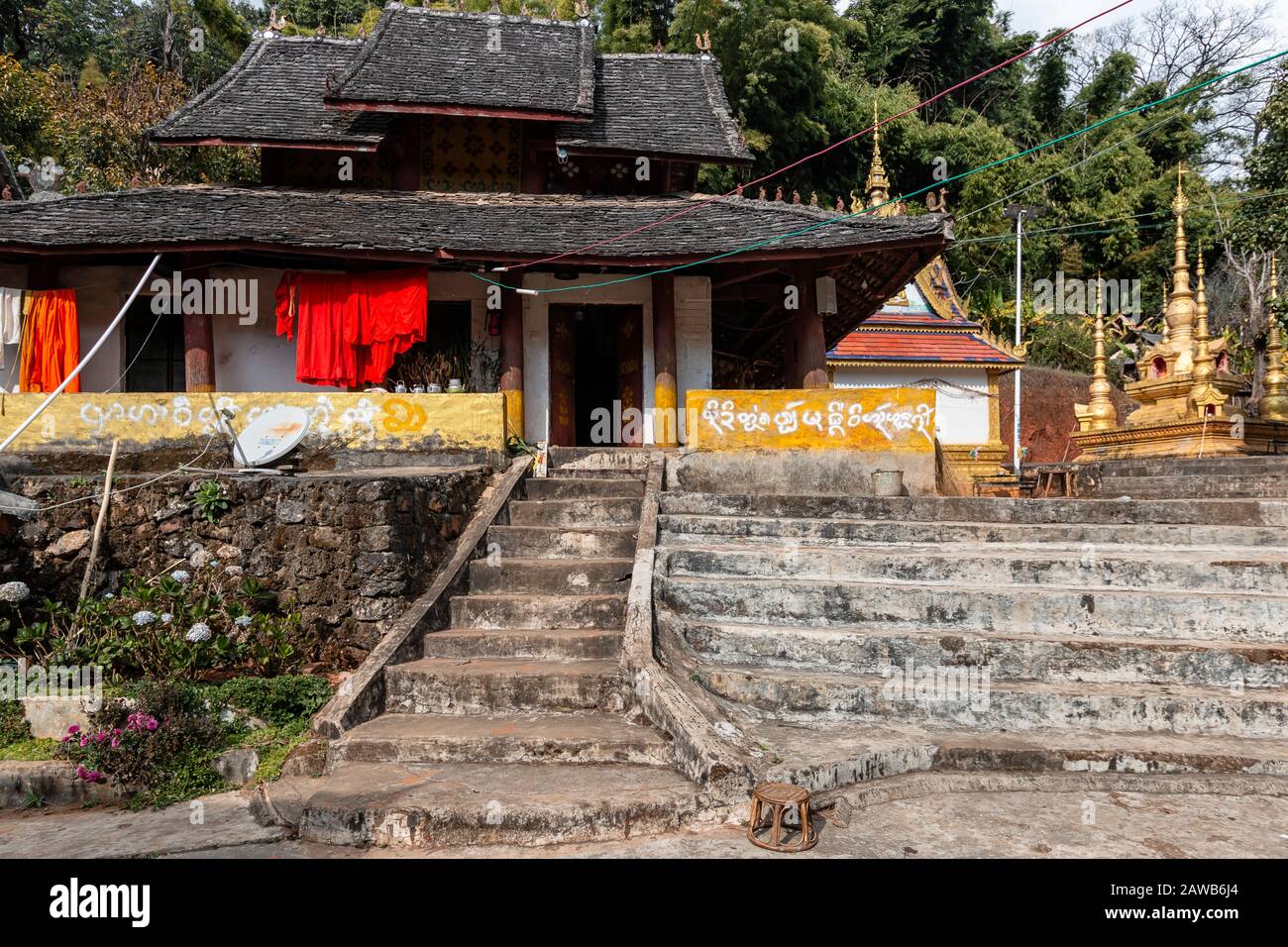 Xishuangbanna, China - December 31, 2019: Dai temple in the countryside of Xishuangbanna. Foreing text saying: Buddhist temple Stock Photo