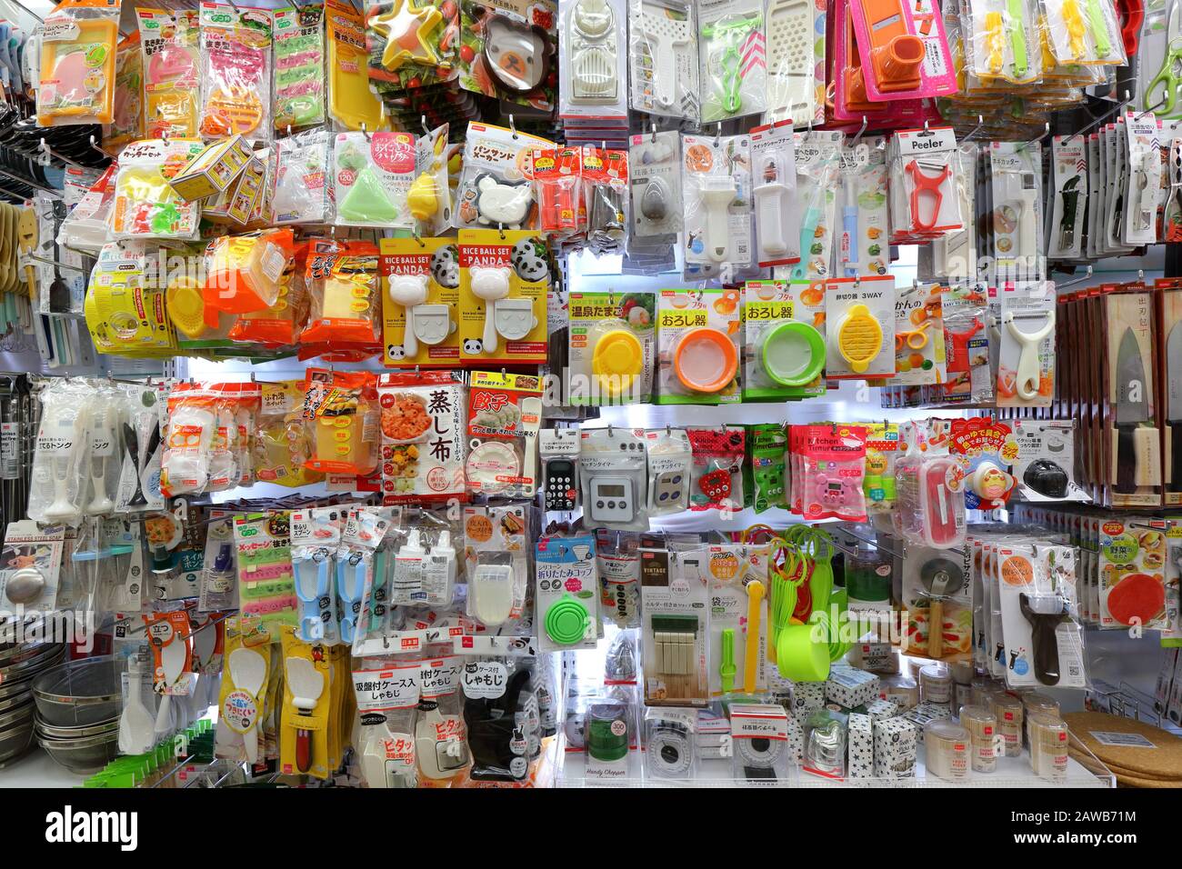 A variety of kitchen tools and gadgets on a shelf at a Daiso store Stock Photo