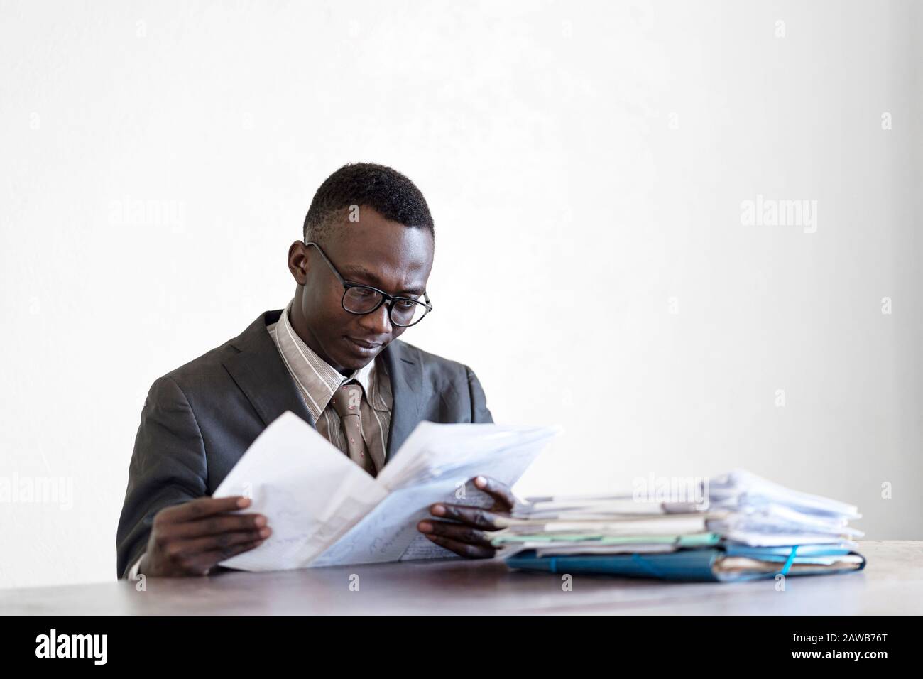 Candid Picture of Young African Ethnicity Business Man Working on His Desk (Businessmen in Africa) Stock Photo
