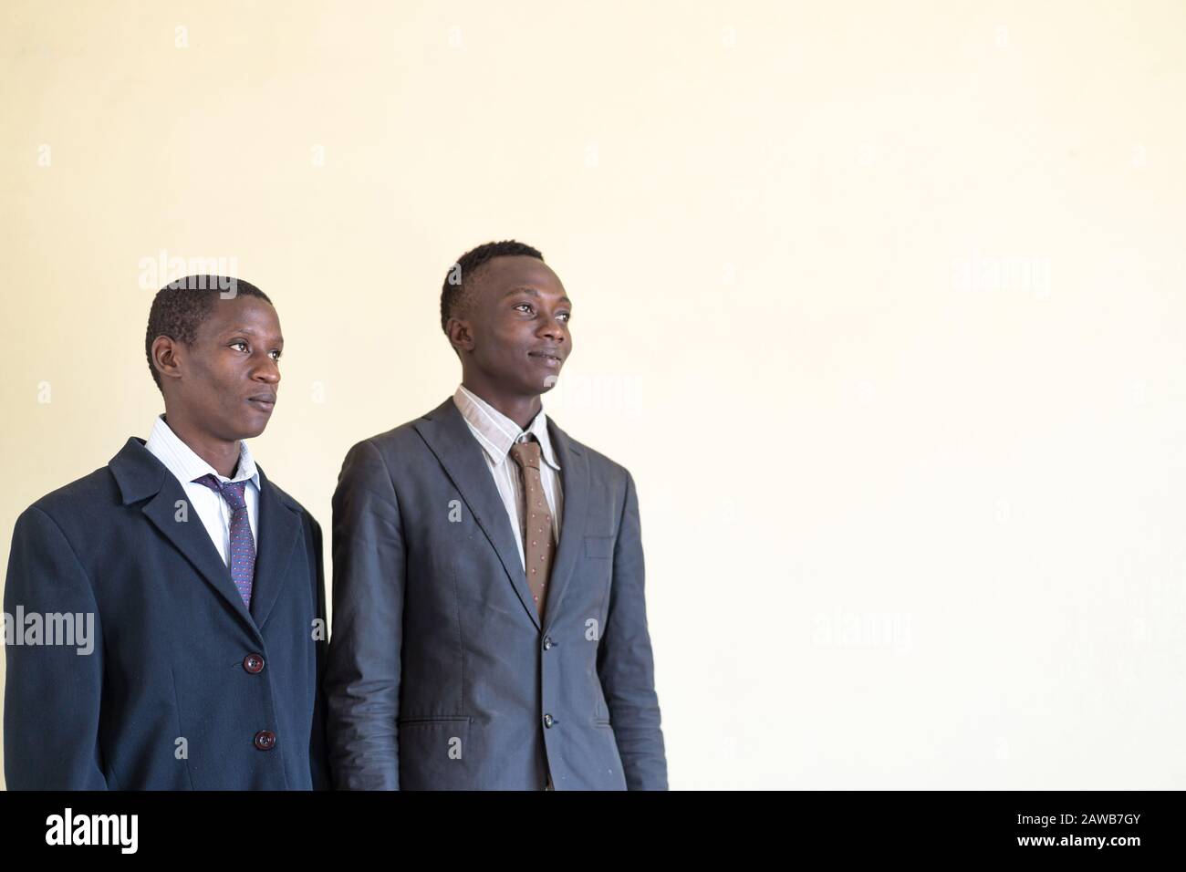 Two Real African Black Businessmen Looking into the same direction Stock Photo