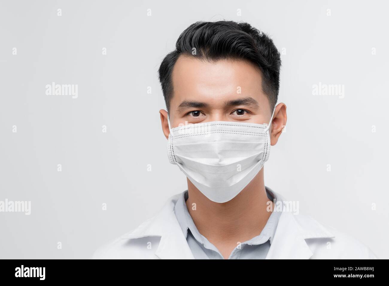 Serious face of male physician looking to camera, warning on epidemic, medicine Stock Photo