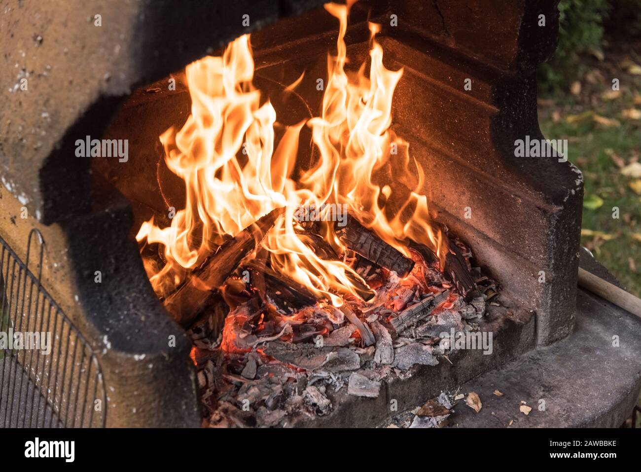 Burning firewood and charcoal in a fireplace chimney, preparation for