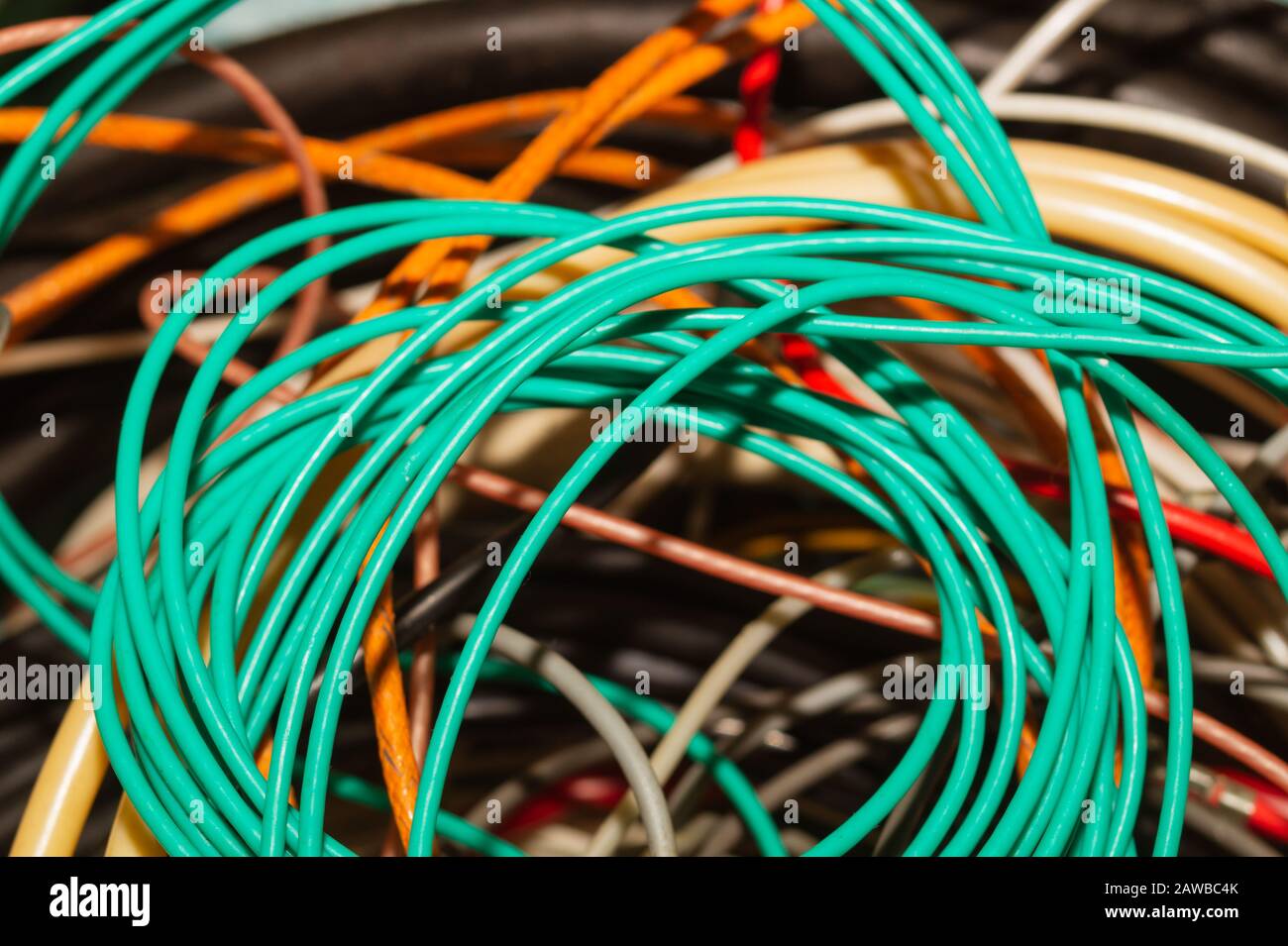 Used electric colorful wires. hank of different old cables close up