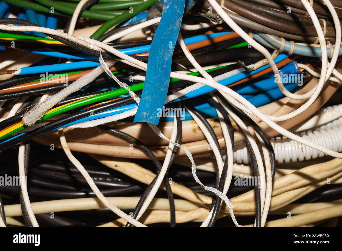 Used electric colorful wires. hank of different old cables close up