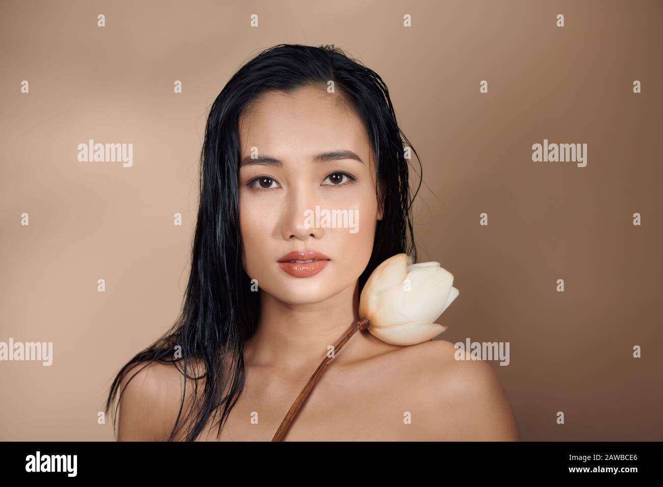 Portrait Of A Beautiful Asian Women Tanned Skin With Long Hair Holding