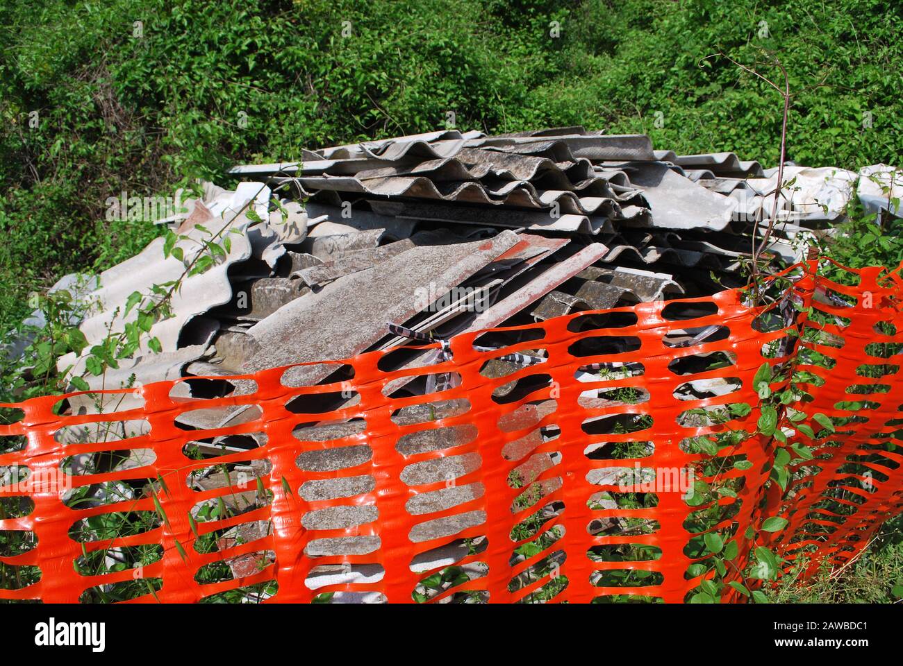 A pile of illegally dumped Asbestos sheets in a country lane. Italy Stock Photo