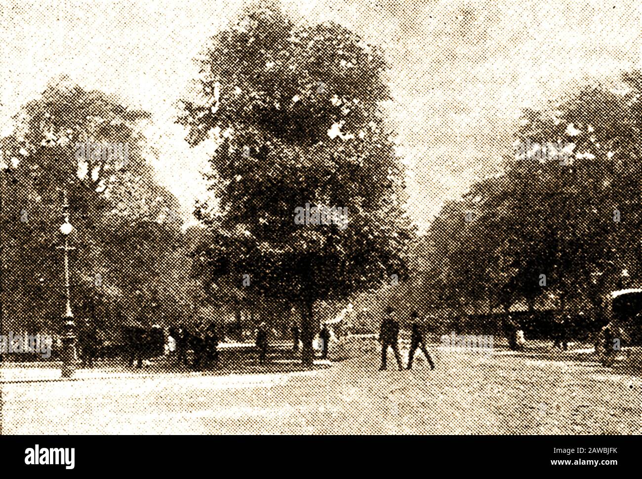 A 1921 newspaper image showing Birdcage Walk, St James Park, London  with Wellington Barracks behind.The street is named after the Royal Menagerie and Aviary which was located there in the reign of King James I and was expanded by  King Charles II. Edward Storey was keeper of the King's Birds at the time of  Samuel Pepys. Until 1828 only the British Royal Family and the  Grand Falconer, (Duke of St Albans), were allowed to drive along the road. The area in the mid  1800's  had a reputation as  a meeting place for homosexual men. Stock Photo