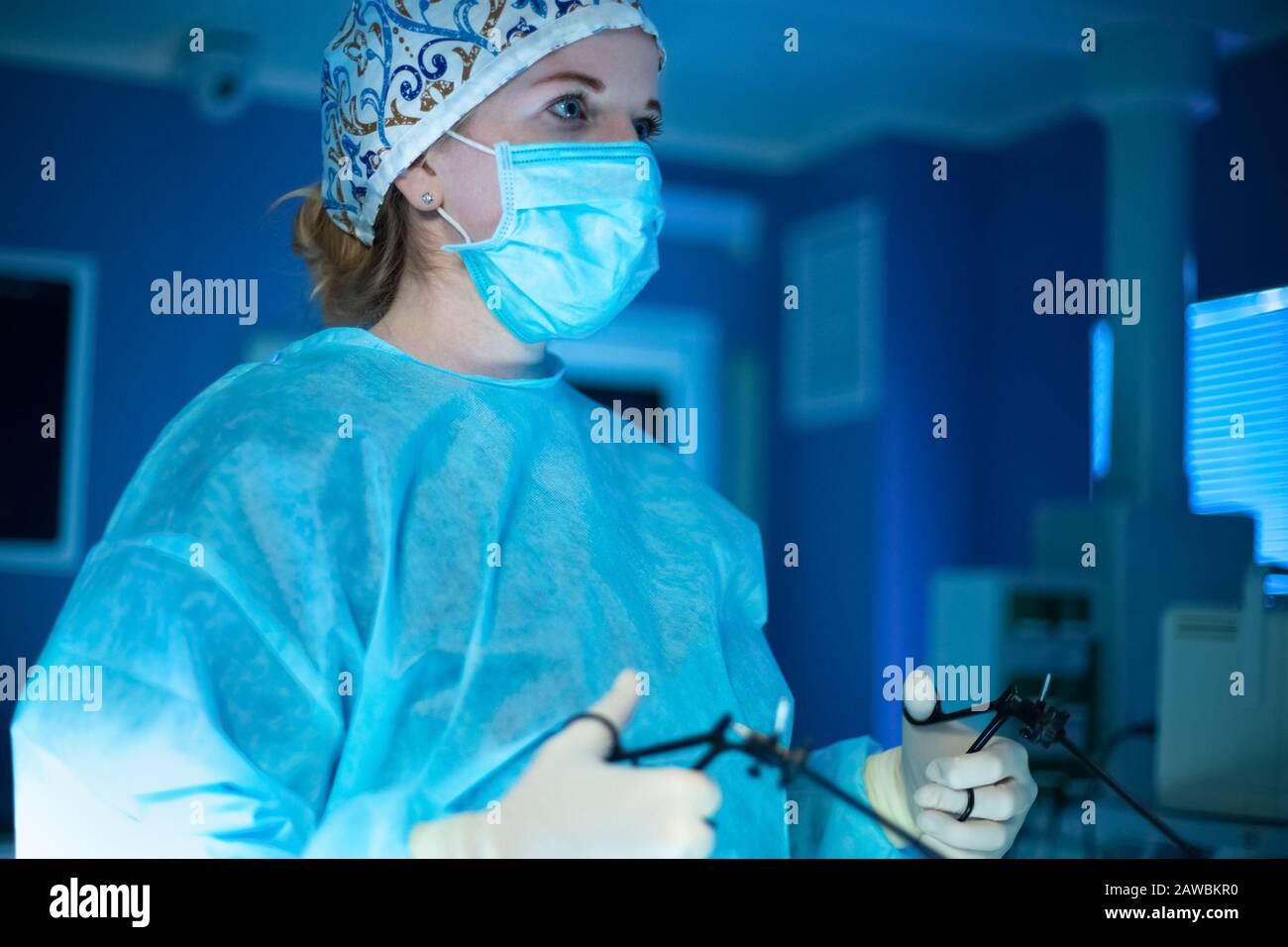 Surgeon woman doing surgical operation with laparoscopic instruments
