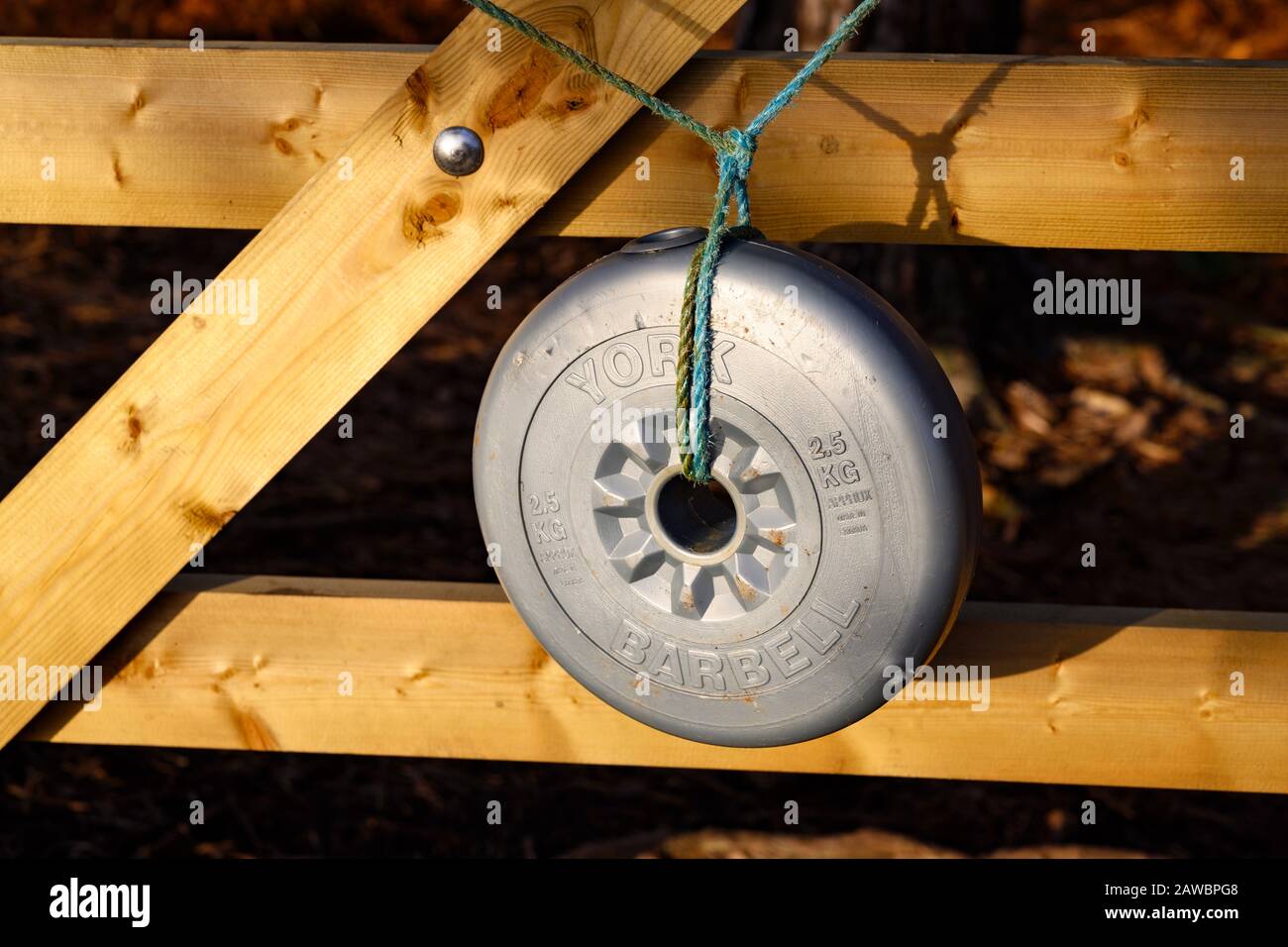 York 2.5kg barbell used as a weight to get a gate closed Stock Photo